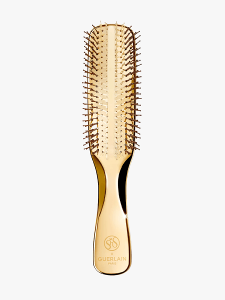 Guerlain Abeille Royale Scalp and Care Hair Brush in branded gold variant on a light gray background